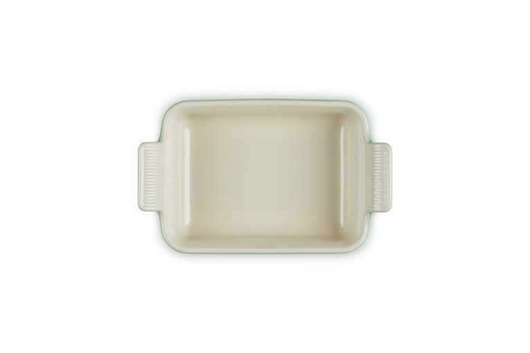 Le Creuset rectangular stoneware dish in bamboo color, top-down view showing handles and smooth interior.