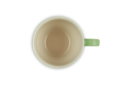Top-down view of a Le Creuset Grand Mug 400ml in bamboo green with a cream interior and handle.