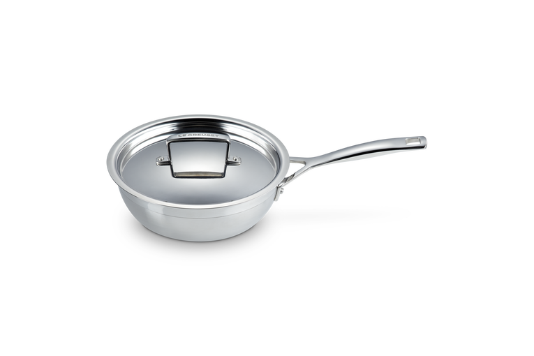 Le Creuset 3-ply 20cm chefs pan with lid, polished stainless steel and long handle on white background.