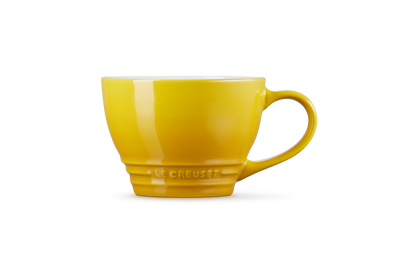 Le Creuset Grand Mug 400ml in bright nectar yellow with a wide handle and embossed logo near the base.
