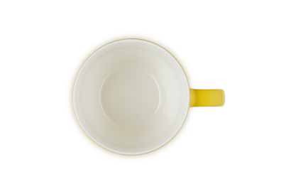 Le Creuset Grand Mug 400ml in nectar yellow, top-down view showing the cream interior and handle.