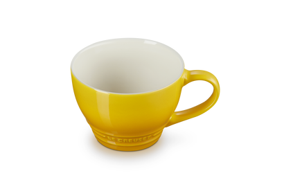 Le Creuset Grand Mug 400ml in bright yellow with a glossy finish, shown from a slight angle.