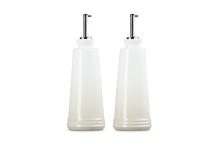 Le Creuset 330ml stoneware oil and vinegar set in meringue with stainless steel pourers, front and back view.