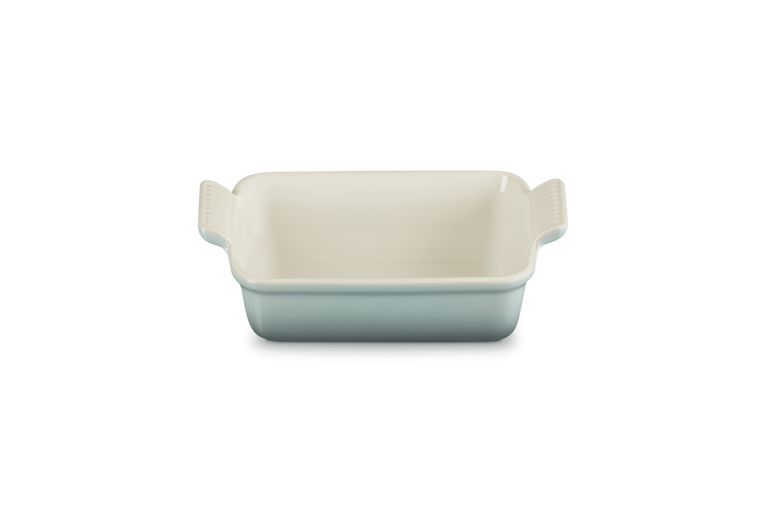 Le Creuset Stoneware Heritage rectangular dish in Sea Salt, shown from the front with handles visible.