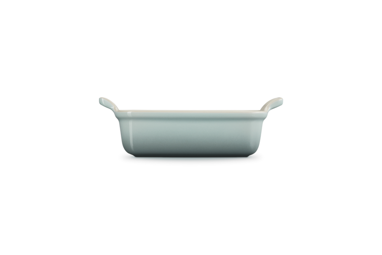 Le Creuset Stoneware Heritage rectangular dish in Sea Salt, side view showing handles and depth.