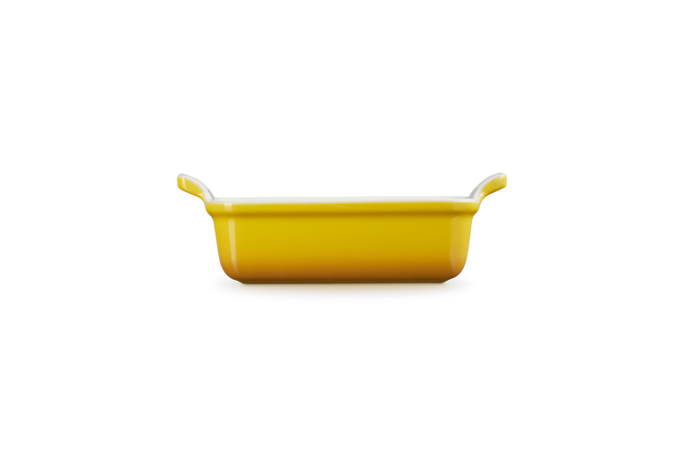 Le Creuset Stoneware Heritage rectangular dish in 19cm nectar yellow, side view on black background