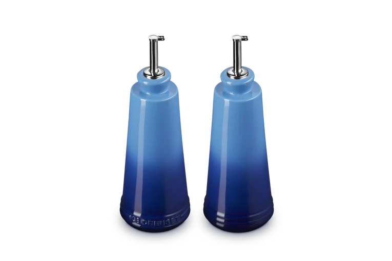 Le Creuset stoneware oil and vinegar set in gradient azure blue with stainless steel pour spouts.