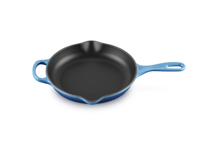 Le Creuset 23cm Signature round skillet in azure blue with black cooking surface and dual pouring spouts