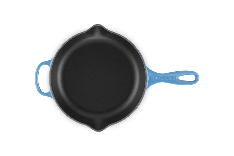 Le Creuset 23cm round skillet in azure blue with black cooking surface, shown from top view.