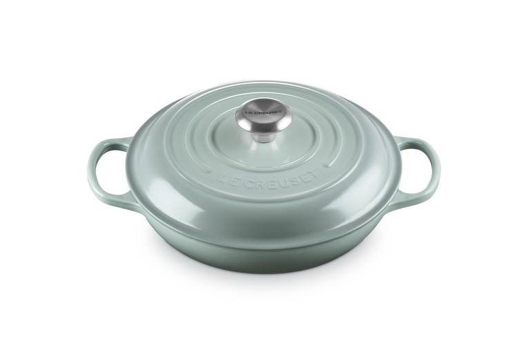Le Creuset Signature cast iron shallow casserole in sea salt with lid and stainless steel knob, top view.