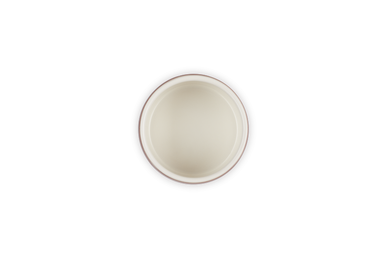 Top view of a Le Creuset Stoneware Stackable Ramekin in garnet with a cream interior.
