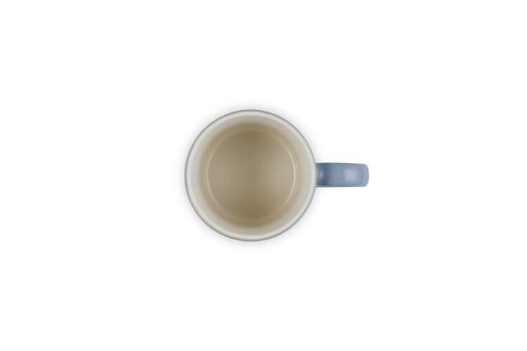 Top view of a Le Creuset Stoneware Espresso Mug 100ml in chambray blue with a cream interior.