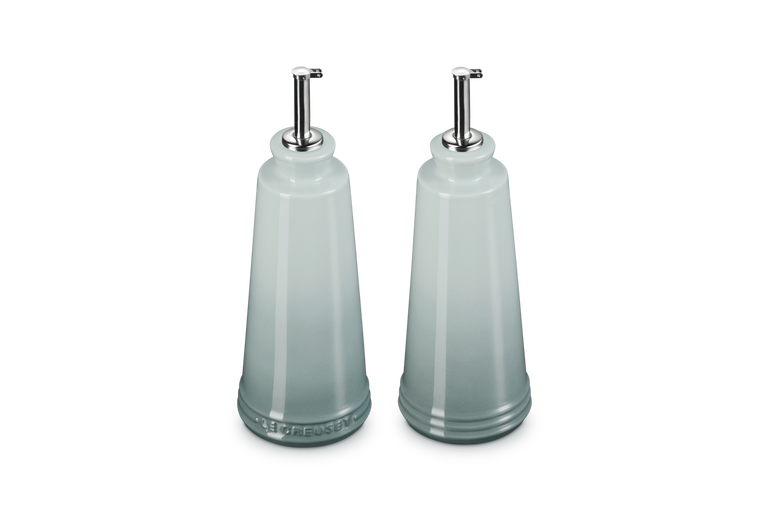 Le Creuset 330ml stoneware oil and vinegar set in sea salt color with stainless steel pour spouts.