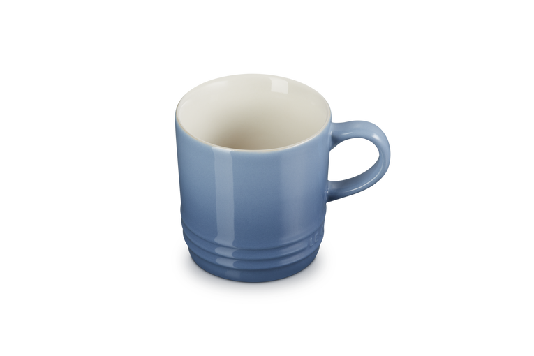 Le Creuset stoneware cappuccino mug in chambray blue with a rounded handle and ribbed base, 200ml capacity.