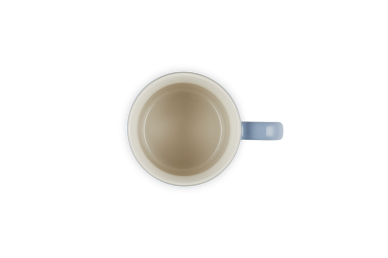 Top-down view of a Le Creuset Stoneware Cappuccino Mug 200ml in chambray blue with a cream interior.