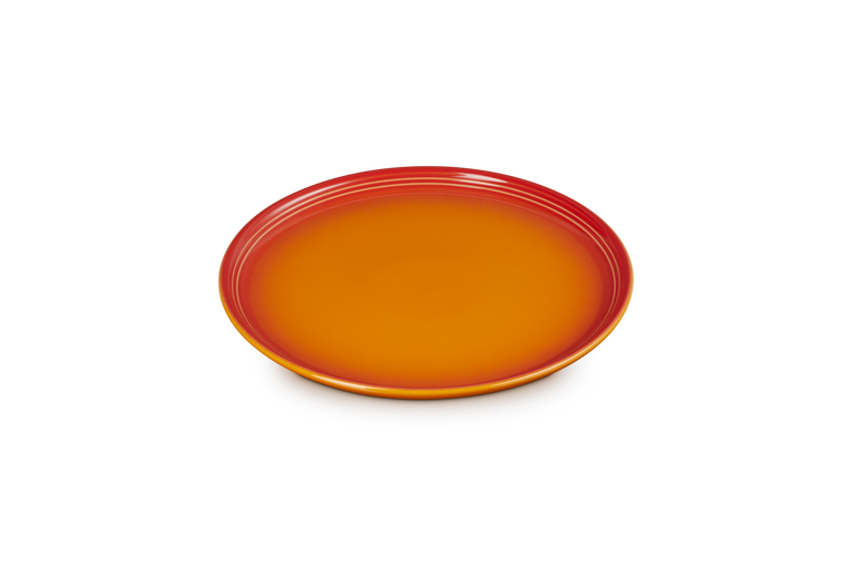 Le Creuset Coupe Side Plate in volcanic orange with a smooth, glossy finish shown from above.