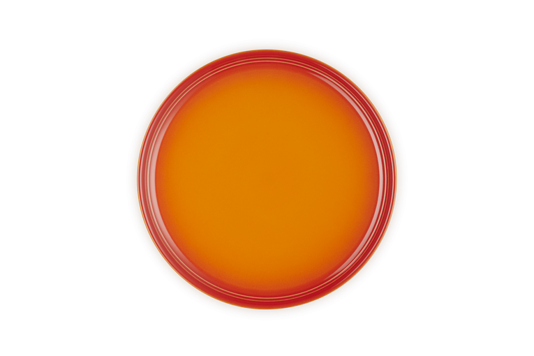 Le Creuset Coupe Side Plate in volcanic orange, shown from a top-down view on white background.