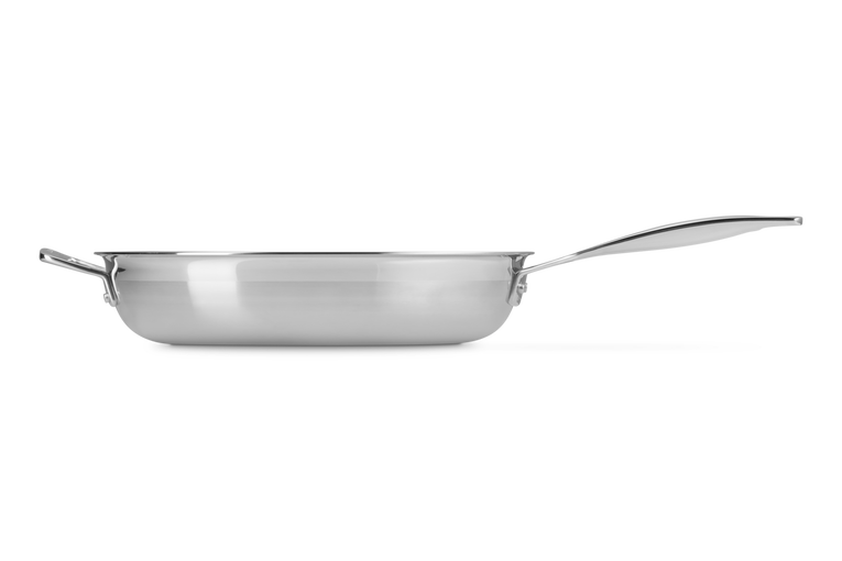 Le Creuset Classic 3-Ply Stainless Steel Frying Pan 30cm shown from the side with long handle and helper handle visible.