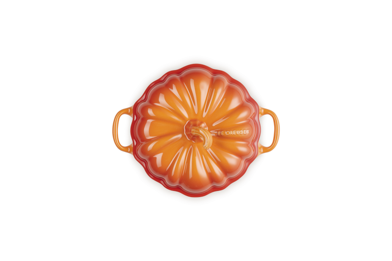 Le Creuset Halloween Pumpkin casserole in volcanic orange, top view showing lid and handles.