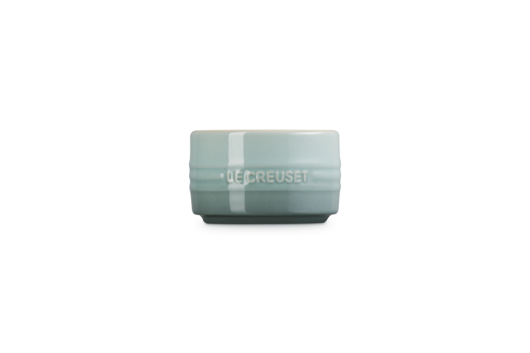 Le Creuset stackable ramekin in sea salt color, shown from the side with logo visible.