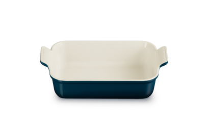Le Creuset rectangular deep dish, 26cm, in Nuit blue with a cream interior, front view.