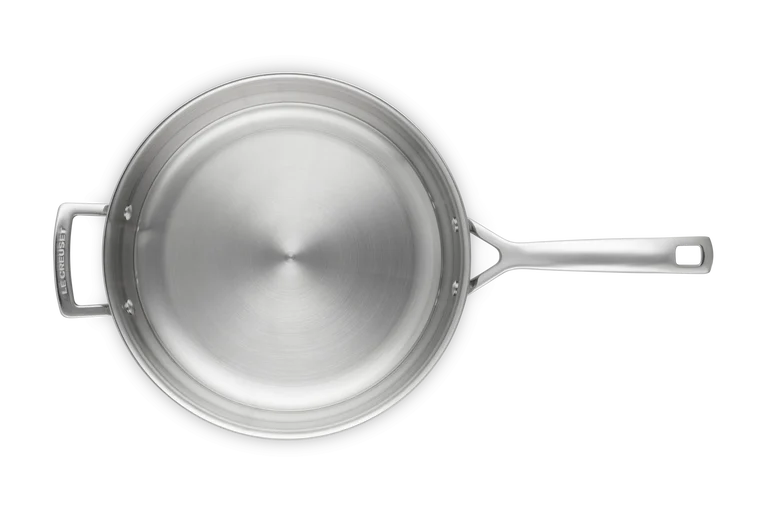 Top-down view of Le Creuset Classic 3-ply stainless steel frying pan, 28cm, showing uncoated interior and handles.