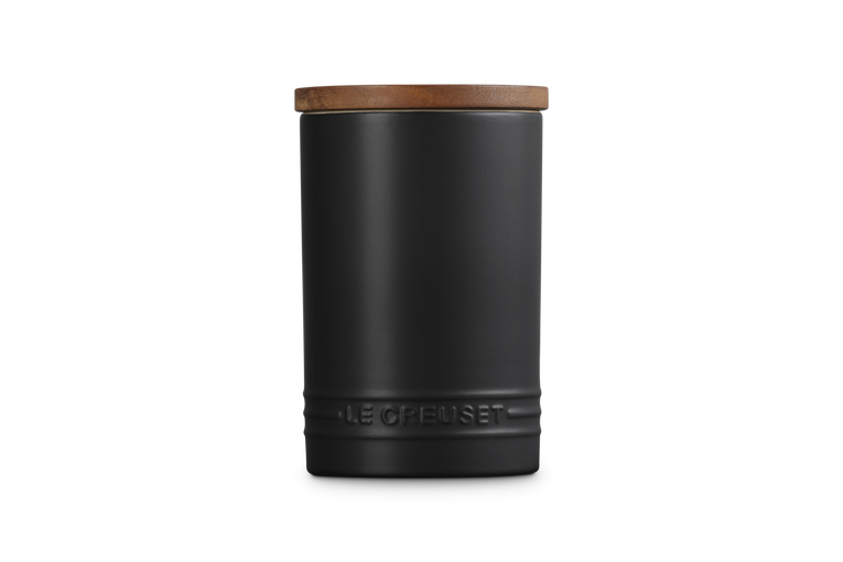 Le Creuset stoneware storage jar in satin black with wooden lid, embossed logo near base.