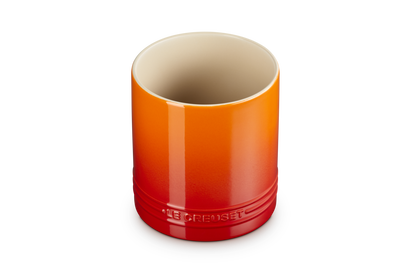 Le Creuset small utensil jar in volcanic orange gradient with embossed logo near the base, shown upright.