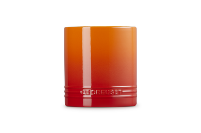 Le Creuset small utensil jar in volcanic orange with glossy finish and embossed logo on front.