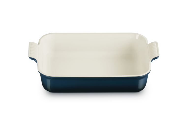 Le Creuset rectangular deep dish, 32cm, with cream interior and dark blue exterior, shown from above.