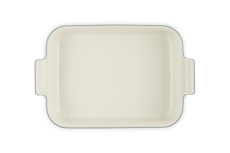 Le Creuset rectangular deep dish in cream, shown from above with handles visible on both sides.