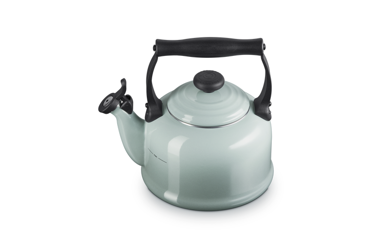 Le Creuset 2.1L Traditional Kettle in Sea Salt with black handle and whistle spout, front angle view.