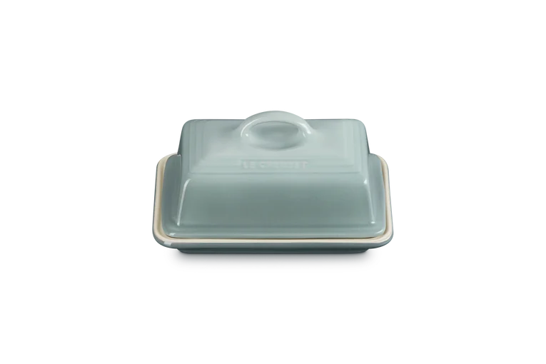 Le Creuset Stoneware Butter Dish in Sea Salt, shown closed with a rectangular lid and handle.