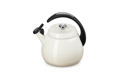 Le Creuset Cloche Kettle 2.1L in meringue color with black handle and spout cover, front angle view.