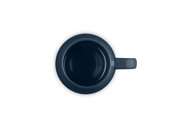 Top view of a dark blue Le Creuset Coupe Mug showing its round shape and handle on the right side.