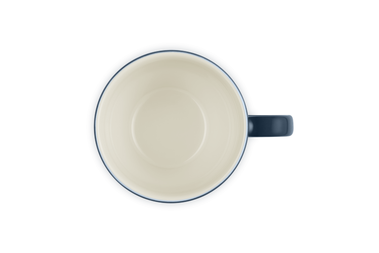Le Creuset Grand Mug Nuit shown from above with cream interior and dark blue handle and rim.
