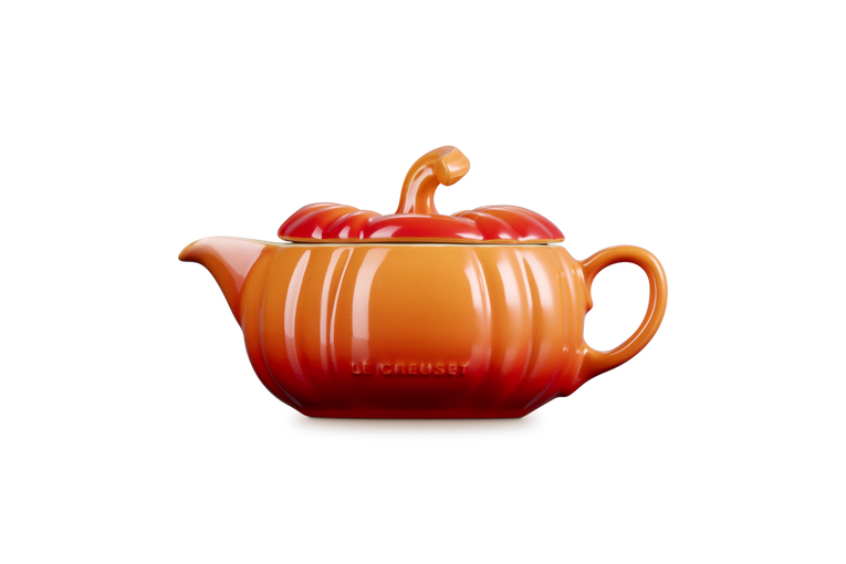 Le Creuset Halloween Pumpkin Gravy Boat in volcanic orange with lid and handle, side view on white background.