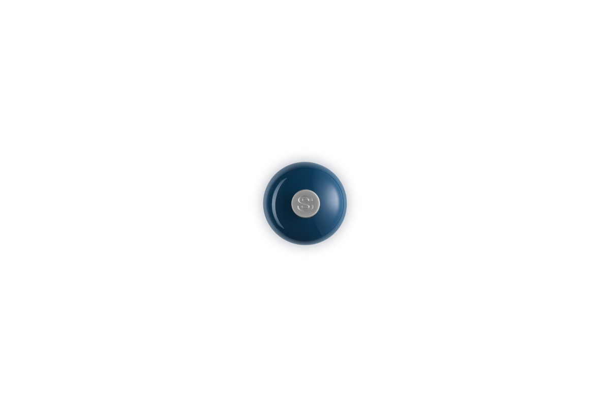 Top view of a navy blue Le Creuset Salt Mill with a silver "S" knob on top.