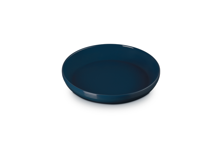 Le Creuset Coupe Pasta Bowl in deep blue, shown from a slightly elevated angle on a white background.