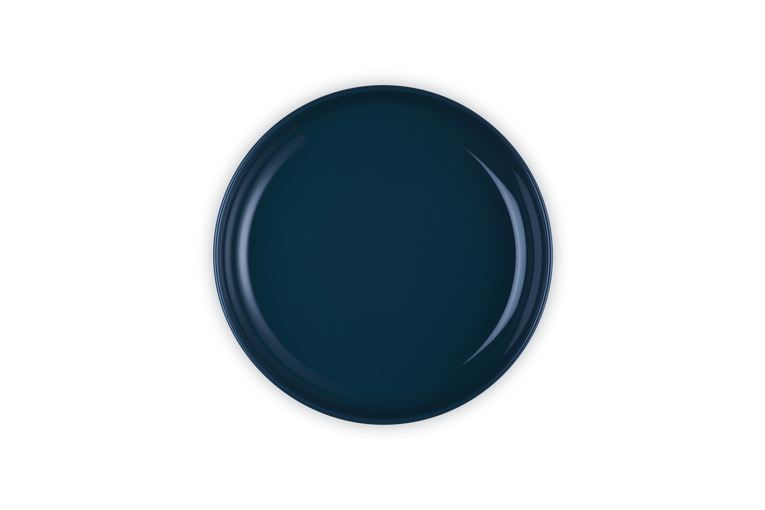 Le Creuset Coupe Pasta Bowl in deep navy blue shown from above on black background