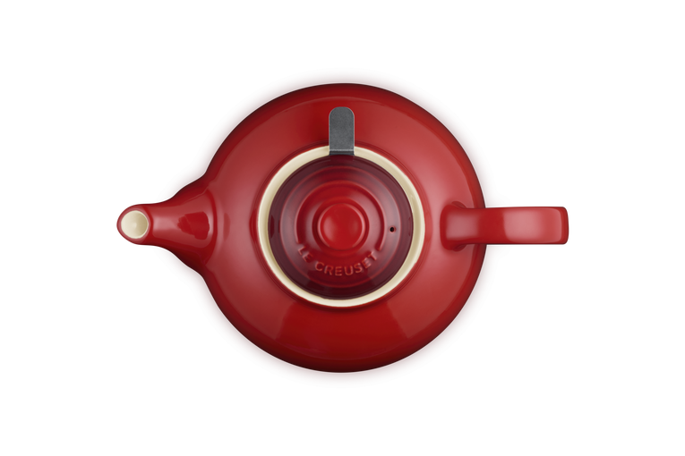 Top view of a cerise Le Creuset Stoneware Classic Teapot with infuser and handle visible