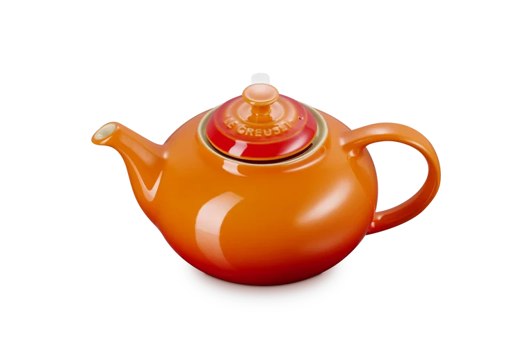 Le Creuset Stoneware Classic Teapot in volcanic orange with lid, shown from a side angle on white background.