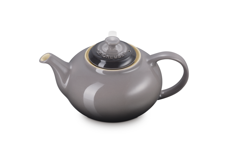 Le Creuset Stoneware Classic Teapot in flint gray with black lid and round handle, angled view.