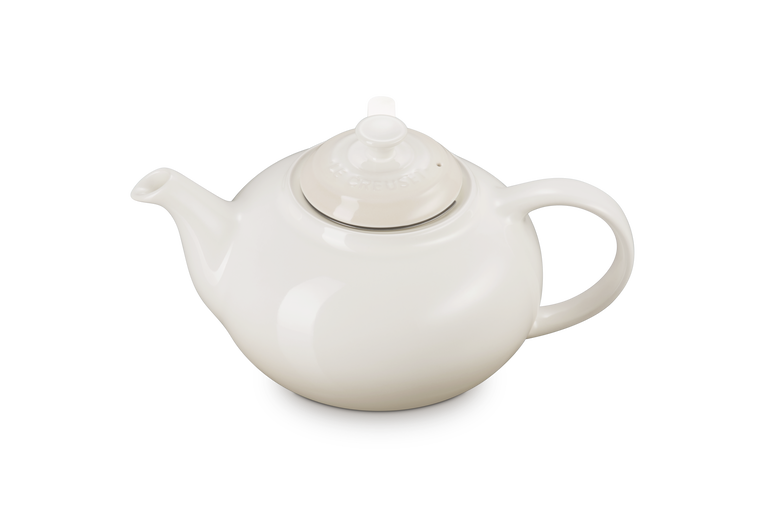 Le Creuset stoneware classic teapot with infuser in meringue, shown from a side angle.