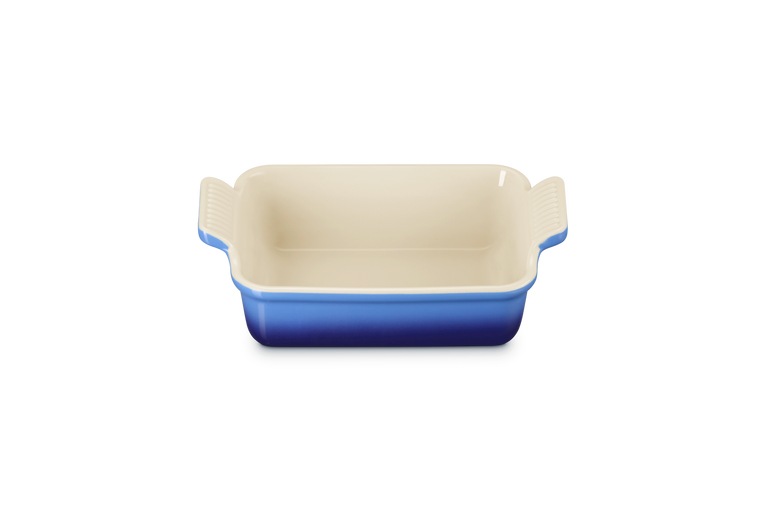 Le Creuset rectangular stoneware dish in azure blue with cream interior, shown from above.
