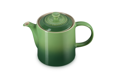 Le Creuset 1.3L Grand Teapot in green gradient with lid and curved handle, shown on white background.