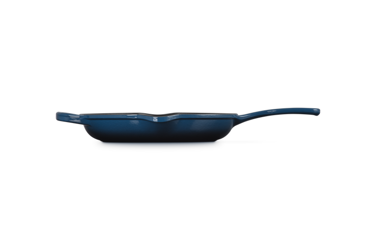 Le Creuset 23cm Signature Round Skillet in Nuit, shown from side with handle and pour spouts visible.