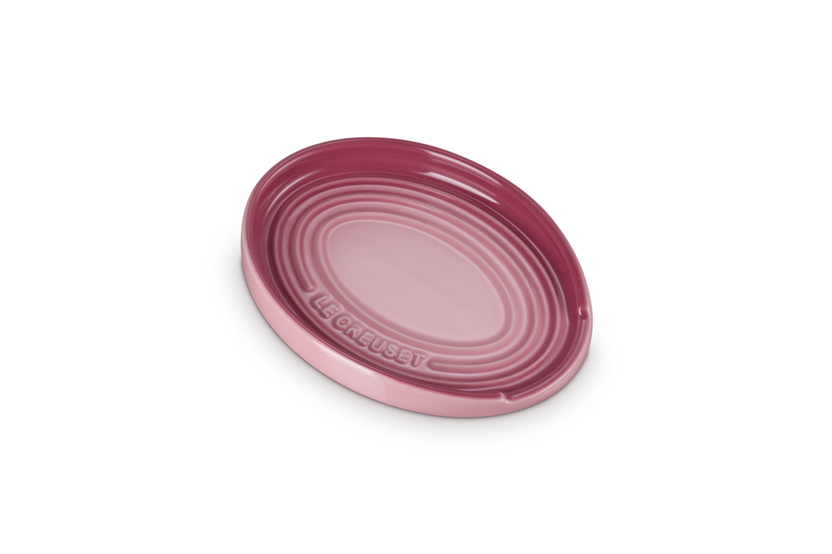 Le Creuset oval spoon rest in rose quartz with concentric ridges and brand name embossed