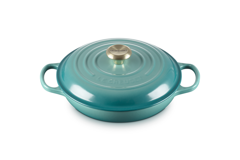 Le Creuset 30cm shallow casserole in Blue Riviera with lid and brass knob, shown from front angle.