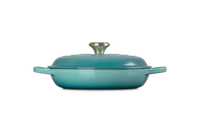 Le Creuset 30cm shallow casserole in Blue Riviera with lid and gold knob, side view on white background